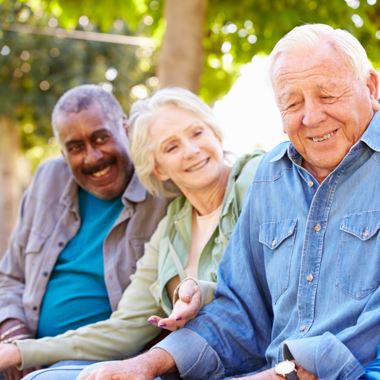 Three seniors sitting outside on a sunny day