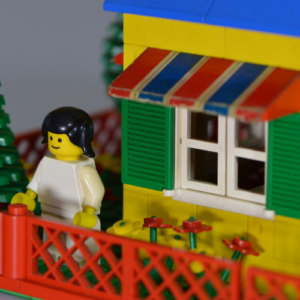 LEGO figurine standing on LEGO porch