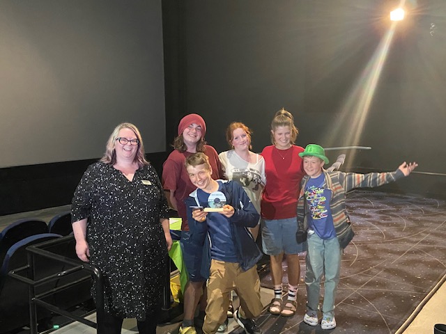 2025 Grey Bruce Youth Film Festival people's choice winners stands with Youth Services Specialist Katie McLeish